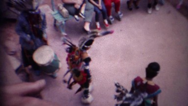 1963: Kids native american indian dancing colorful ancient costume.