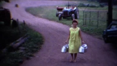 1963: Exotic Asian women carrying milk pails at rural dairy farm.