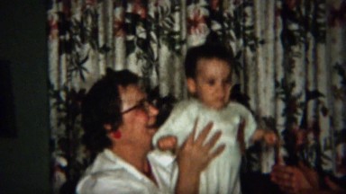 1958: Grandma Passes Baby to Grandpa Practice Clapping