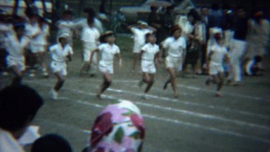 1961: Asian schoolgirl foot race running track white uniform event.