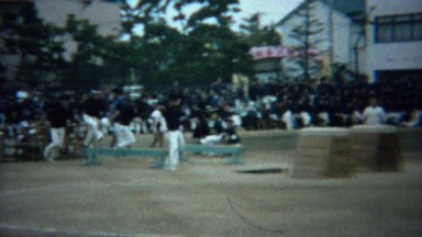 1961: Asian schoolboy obstacle course competition jump race.