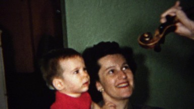 1959: Mom and Baby Skeptically Watch Violin Music Player Strum.