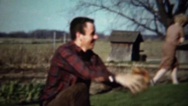 1961: Dad baseball catcher at rustic farm field of dreams background.