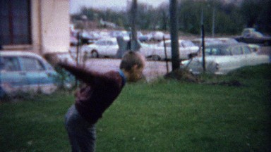 1962: Teenage boy dad toss horseshoes clowning around at park.