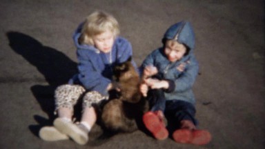 1963: Kids bother cat with rough play runs away for safer times.