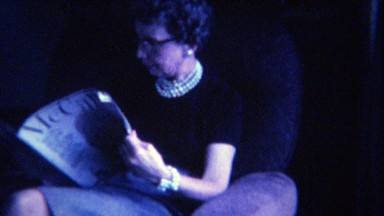 1963: Classy older women pearl necklace reading McCall's magazine.
