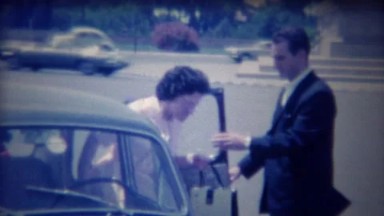 1963: Italian Chauffeur Opens Car Door for Amazed Lady Tourist