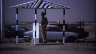 1974: Traffic checkpoint police guards roof shade structure.