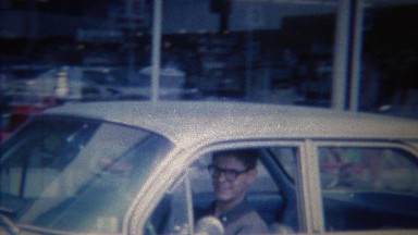 1963: Teenage Boy Nervously Learning to Drive Removes Eyeglasses