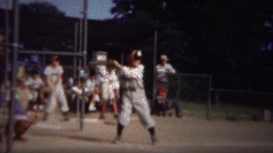 1964: Boy batting little league baseball game takes bad pitches.