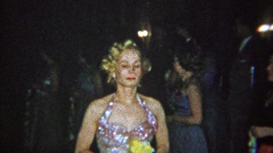 1965: Solemn adult sorority sisters walking slow ceremony event.