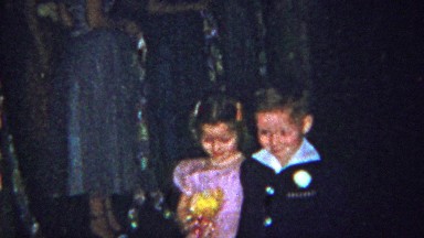 1965: Flower girl and ring bearers walk down wedding aisle.