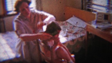 1954: Impatience Mom Brushing Daughter's Knotty Hair in Bedroom