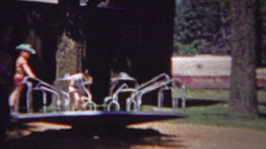 1954: Kids Playground Carousel Spin Hold Tight Fun Playground Party.