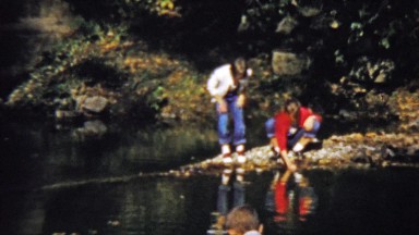 1959: Kids play water reflection looking for aquatic wildlife.
