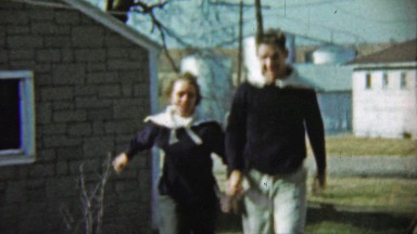 1959: Couple wearing matching navy sweater type outfits.
