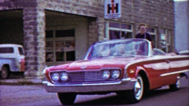 1959: Women beauty queens riding convertible car summer parade.