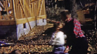 1959: Cute kids play rough autumn home construction site.