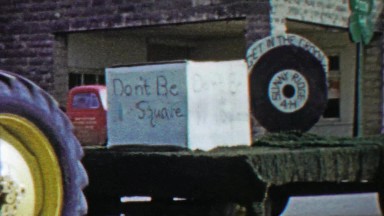 1958: Don't be a square farm tractor parade float get in the groove.