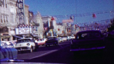 1958: Christmas holiday decoration red bells blue stars downtown mainstreet.