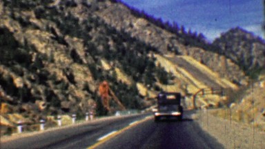 1958: Interstate highway 70 two lane road past mining tailings.