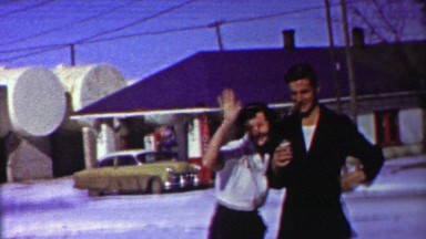1958: Man smoking cigar drinking beer neighborhood bar older woman.