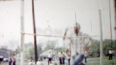 1958: Teenage boys practice high jump sports technique leaping.