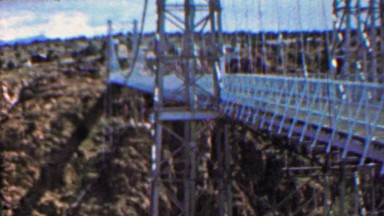 1961: Royal Gorge bridge man walking across national park.