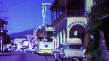 1962: Mainstreet driving small town commercial district.