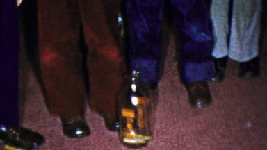 1963: Crowd gathers party game classic drop closepin bottle.
