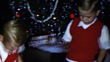 1963: Christmas tree grade school boys gang red sweater vests.