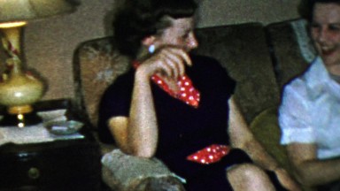 1963: Sisters laughing couch family gathering smiling happy times.