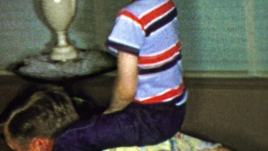 1963: Boy riding dad around living room past floor tube tv.