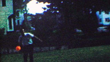 1963: Glowing ball catch game throw nighttime backyard last light.
