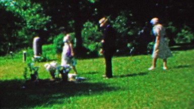 1963: Family visits gravesite beloved pray respect empathy.