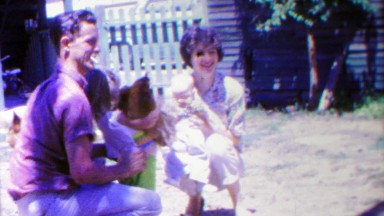 1963: Farm family daughter holding chickens mother caring baby.