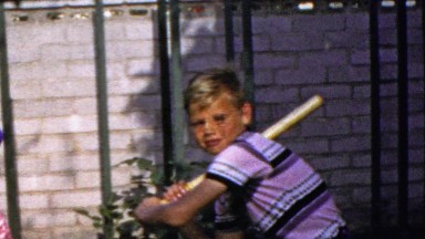 1964: Suntanned young middle school boy baseball bat stance.