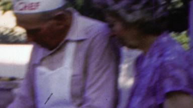 1964: Big chef outdoor grilling wife helps cook sidekick support.