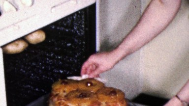 1961: Mother cooks ham pineapple glazed oven party feast.