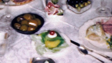 1961: Family formal dining feast plates of appetizers foods.