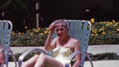 1961: Women suntanning poolside lawn chairs bathing suits lounge.