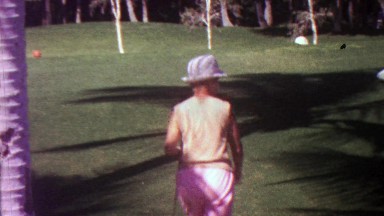 1963: Women golfer tee driver markers warm tropical day.