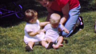 1957: Toddler bites baby brother's head tears ensue mother rescues.