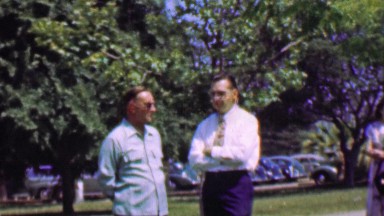 1957: Men talking important serious business on a Sunday in a park.