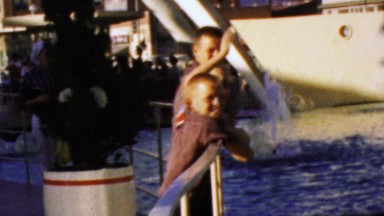 1964: Young Boys Enjoying Cultural Beauty of Water Fountain Sculpture