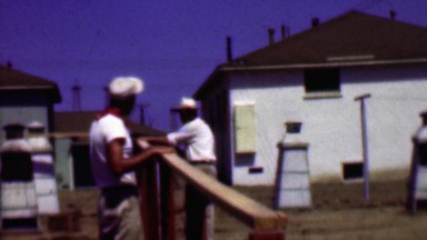 1957: Construction men debating project details on clear summer skies.