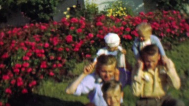 1957: Dad carry baby rides dangerous shoulder grip posture.