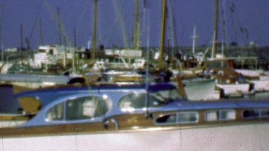 1958: Wood paneled yacht boats in harbor marina docking waters.