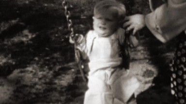 1961: Mother Helps Baby Swing on Thick Chained Sturdy Swing Set