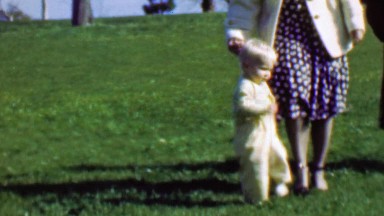 1961: Mother Training Baby to Walk Falls Down Trying Learn Legs